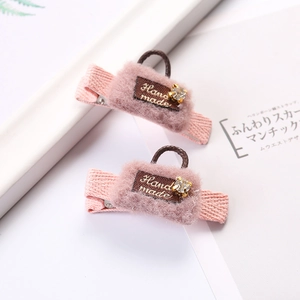 Pink plush handbag shaped hair clips with handmade labels and crystal stone accents