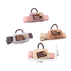 Set of 4 plush bag-shaped hair clips in pink, grey, beige, and camel with rhinestone accents