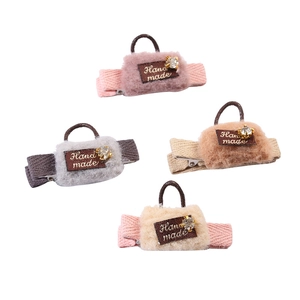 Detailed view of handmade mini plush bag hair clips in pink, grey, beige and brown