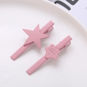 Pink matte star and smiley flower hair clip set on a white plate for women