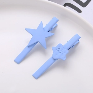 Light blue matte star hair clips set on white ceramic plate for minimalist styling