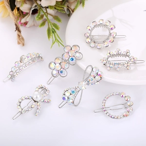 Detail of seven silver alloy hair clips with colorful rhinestones and pearls