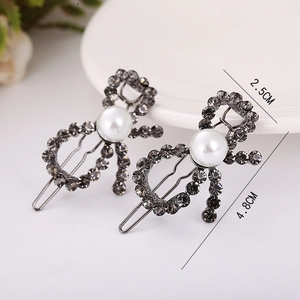 Detailed view of grey rhinestone bowtie hair clips with central pearl and dimensions