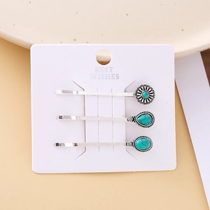 Macro shot of three vintage silver hair clips featuring turquoise stone inlay details