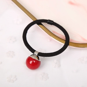 Elegant hair tie with black elastic cord and polished red bead on lace background