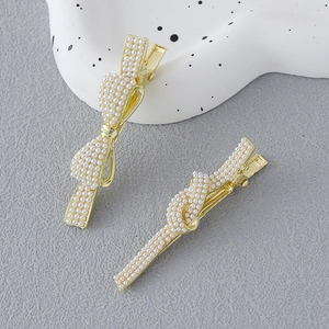 Elegant gold pearl bow hair clips set for women with vintage minimalist knotted design