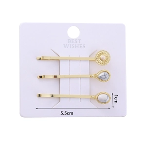 Detail view of gold alloy hair clip set with sun flower and marble stone inlays