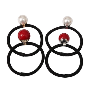 Minimalist elastic hair ties set with pearl and red bead accents on black cords