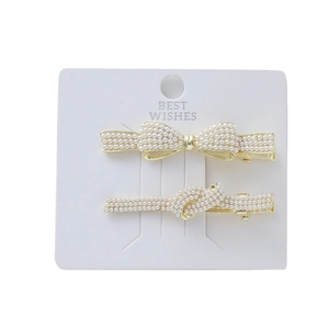Elegant two-piece gold hair clip set with white pearls and butterfly bow design