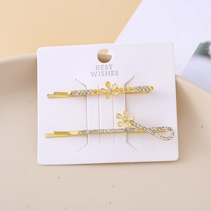 Elegant gold daisy hair clips with cat eye stones and sparkling crystals on card
