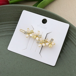 Elegant gold alloy hair pin with three cream opal butterfly flower motifs and crystals