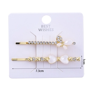 Detailed view of 7.3cm golden hair clips with cat eye stone butterfly and heart shapes