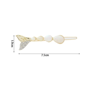 Detail view of a 7.5cm gold fish tail hair clip with rhinestones and opal stones