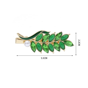 Detail view of a 5.5cm vintage green wheat leaf hair clip with pearls and crystals