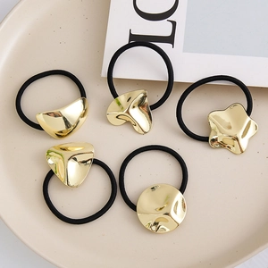 Five-piece set of black elastic hair ties with gold geometric metal heart and star accents