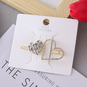Elegant gold alloy hair clip with double heart crystal design on Best Wishes card