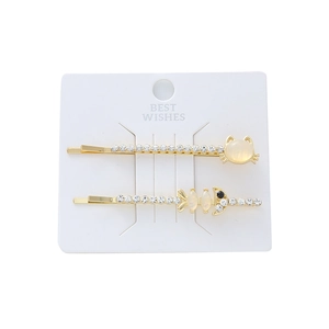 Lot de deux barrettes dorées avec motifs chat et arête de poisson ornés de strass brillants