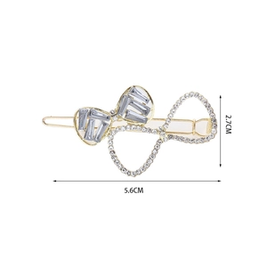 Bow hair clip details with dimensions 5.6cm by 2.7cm and sparkling crystal inlay