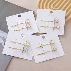 Elegant gold celestial hair clips set featuring moon shapes and iridescent beads