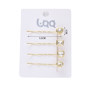 Detailed set of four gold-plated hair clips with crystal heart and geometric shapes