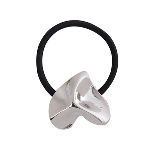 Close-up of a silver irregular heart metal charm on a black high-elastic hair tie