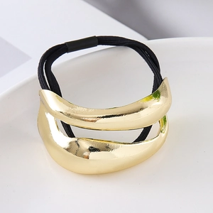 Detail of gold minimalist curved metal ornament on elastic high-stretch black hair tie