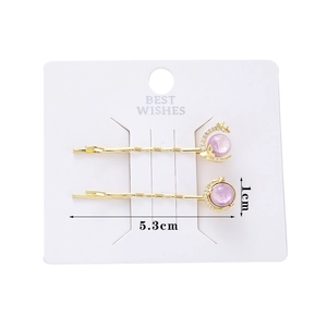 Detail showing two galaxy moon stars hair clips with purple pearls and dimensions