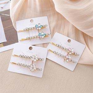 Set de horquillas de flores con cristales brillantes sobre base de metal dorado