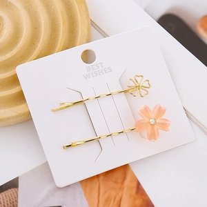 Elegant floral hair clip set featuring golden petals and crystal-studded cherry blossom design