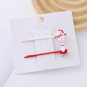 Christmas hair clips set featuring Santa Claus and snowman motifs on a white display card
