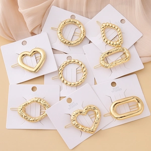 8-piece set of gold geometric metal hair clips with textured heart and star shapes