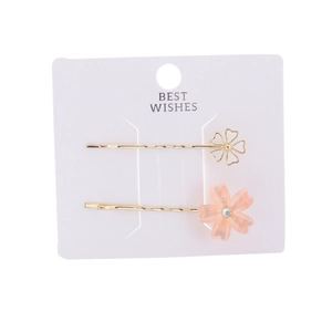 Detail of gold metal hair clips with cherry blossom resin flower and crystal inlay