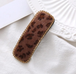 Close-up of velvet leopard print BB clip with champagne rhinestones and metal base