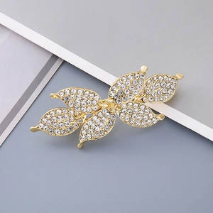 Elegant gold butterfly hair clip with sparkling white rhinestones in a minimalist design