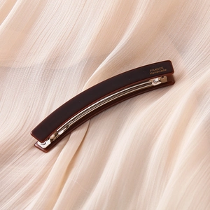 Detail of dark brown leopard banana hair clip with France Handmade gold engraving