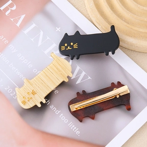 Three-piece cat-shaped hair clips set in black, wood, and tortoiseshell acetate finish