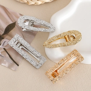 Elegant 4-piece metallic hair clip set in gold and silver with textured baroque finish