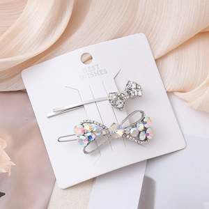 Elegant bow hair clip set with sparkling AB rhinestones and pearls on silk fabric