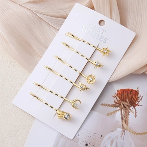 Six-piece set of gold rhinestone hair clips featuring star, moon, and wing shapes