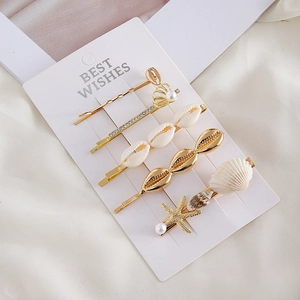Set de 5 barrettes dorées sur le thème marin avec coquillages, perles et étoiles de mer