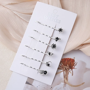 6-piece Gothic silver star and moon hair clips set with black rhinestones on card