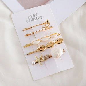 Détail du lot de 5 pinces à cheveux océan avec étoiles de mer dorées, perles et coquillages
