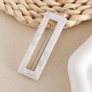 Minimalist marble pattern rectangle hair clip with elegant french style on a neutral background