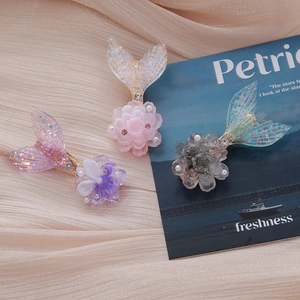 Detailed view of colorful mermaid tail flower hair clips in various pastel shades