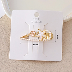 Detailed view of ocean theme hair clip with starfish, shell, pearls and size specs