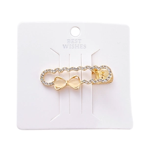 Golden safety pin hair clip with rhinestones and cat-eye stone bow decoration