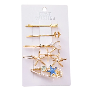 Lot de 5 barrettes thème océan avec étoile de mer dorée et perles sur carte de vente