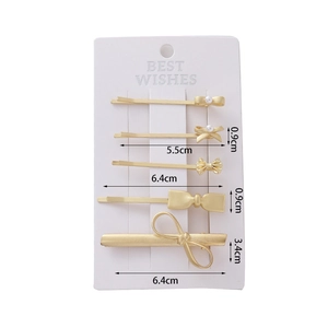 5-piece set of matte gold bow hair clips with pearls and size measurements shown