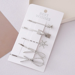 5-piece silver bow hair clip set with rhinestone accents on a display card