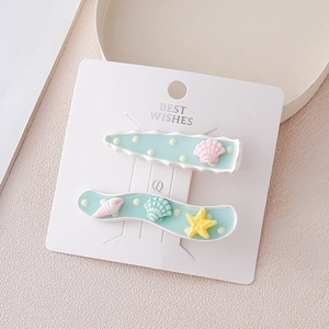 Barrettes étoile de mer et coquillage à pois blancs sur pinces bec de canard vert menthe